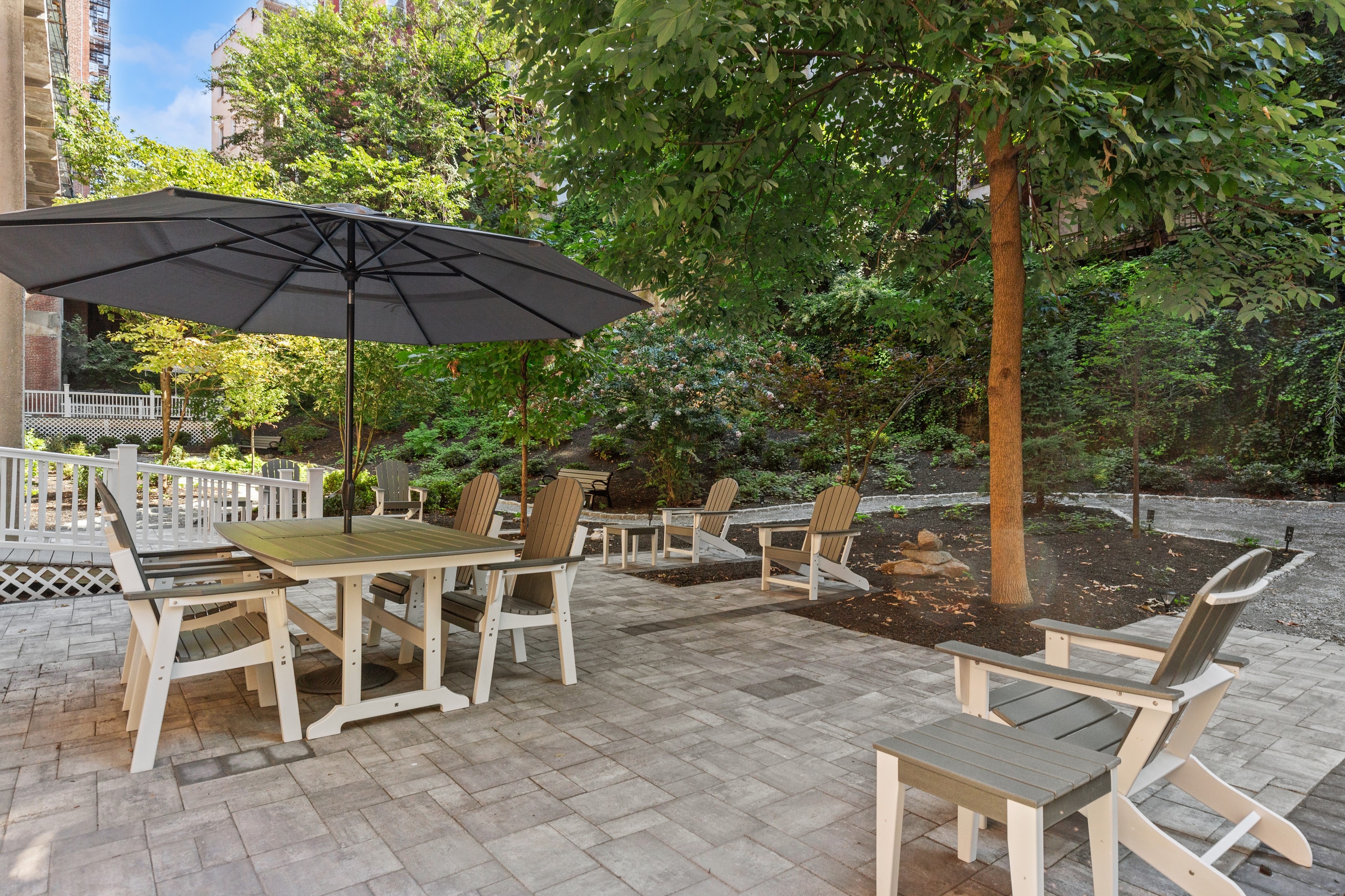 158-18 Riverside Drive West, Unit 2M Manhattan, NY 10032 - Photo 9 of 21 a view of a patio with a table and chairs under an umbrella
