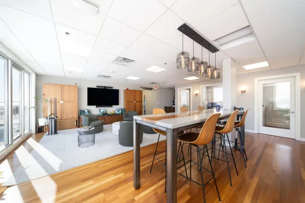 a view of a dining room with furniture window and wooden floor