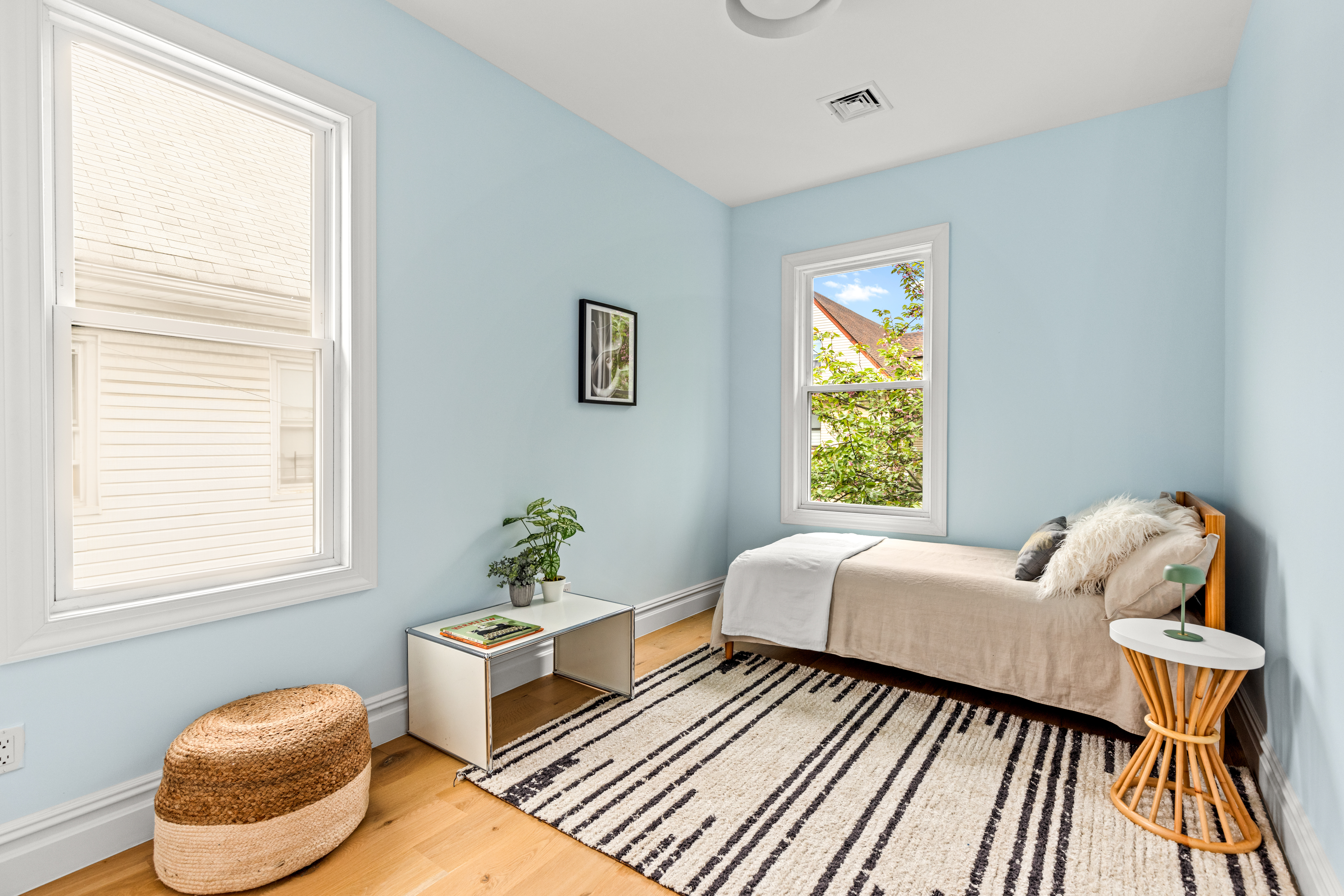 409 East 4th Street Brooklyn, NY 11218 - Photo 7 of 19 a living room with a bed and a window