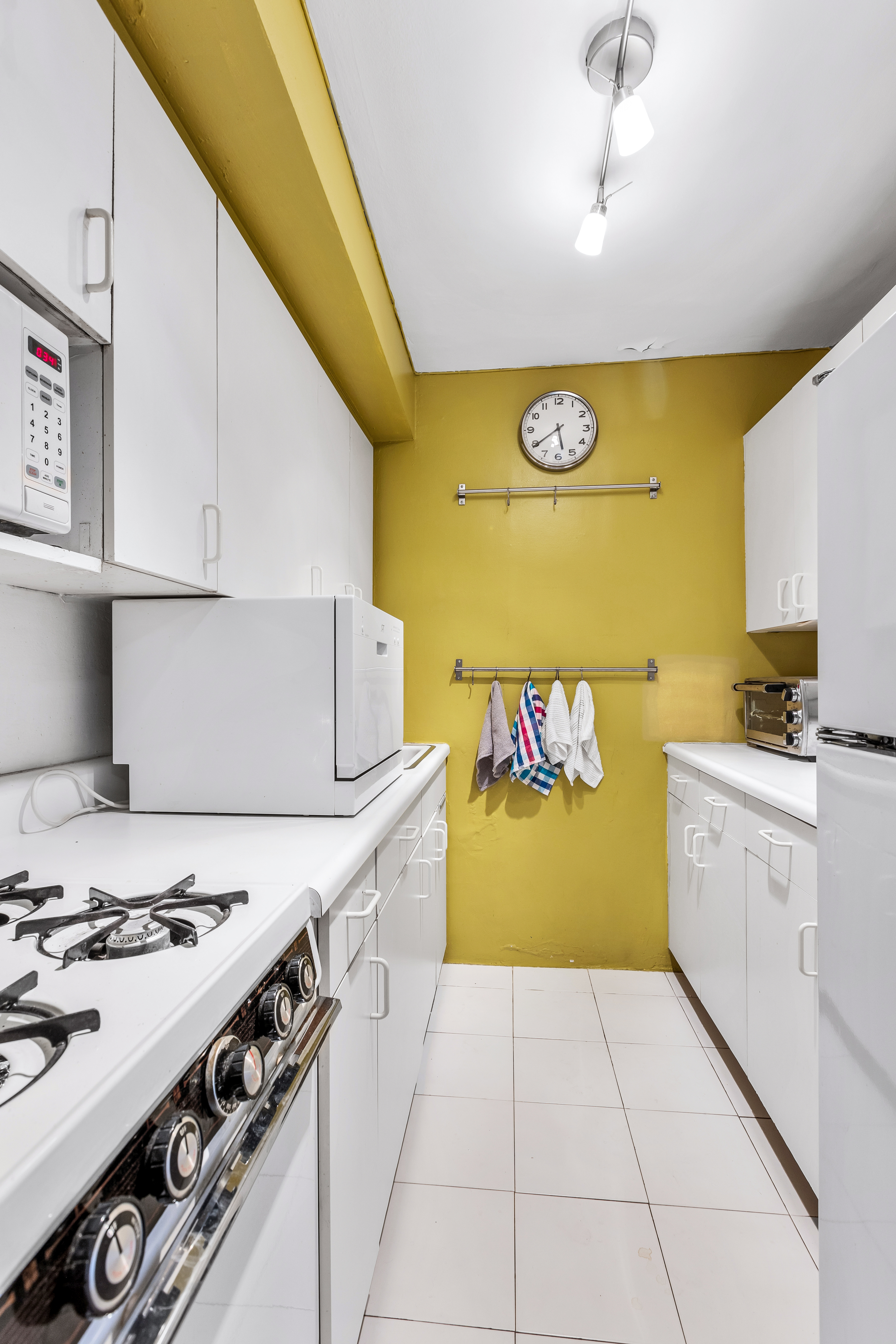 345 East 81st Street, Unit 19A Manhattan, NY 10028 - Photo 10 of 22 a kitchen with a stove a sink dishwasher and a refrigerator