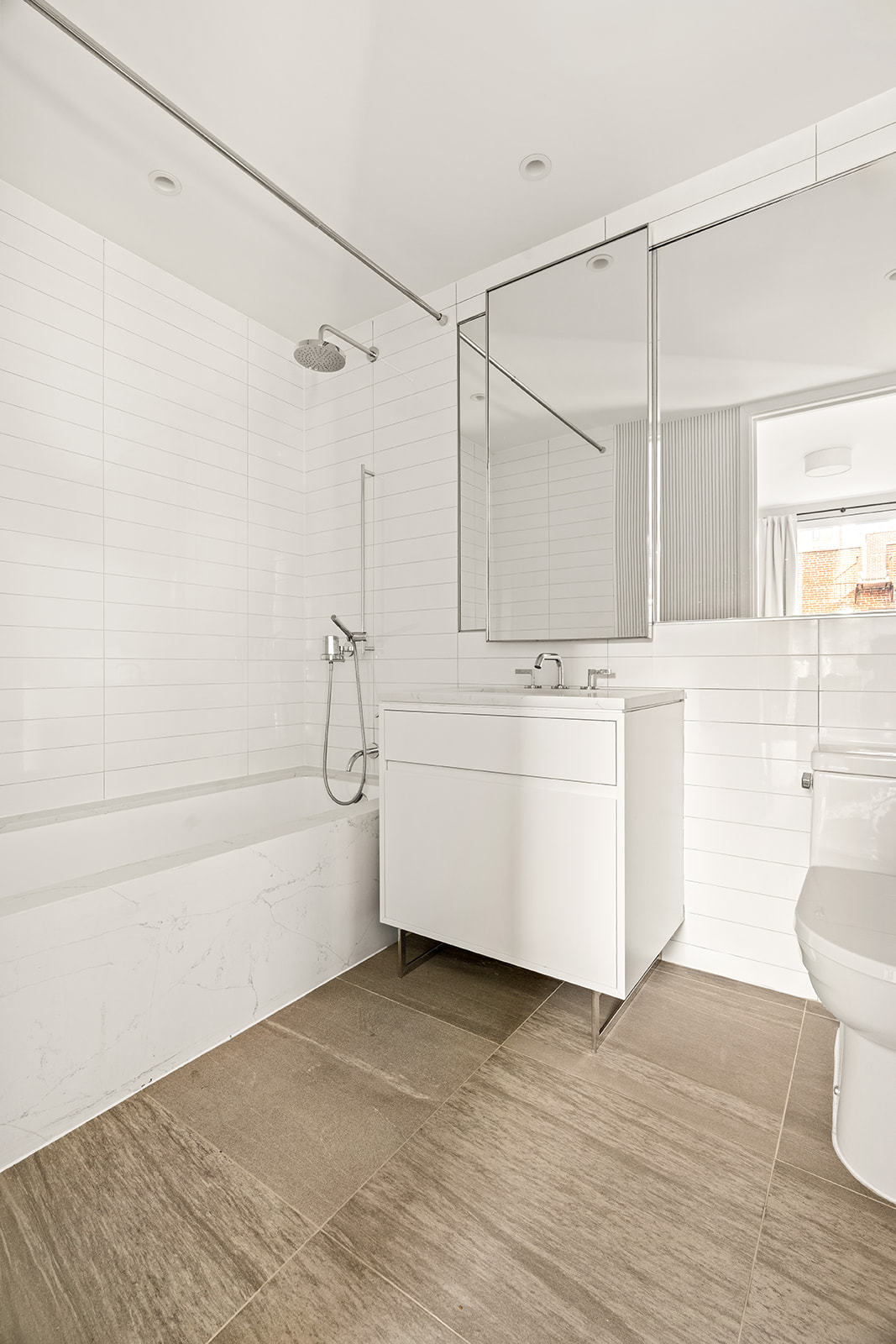 150 East 23rd Street, Unit 5D Manhattan, NY 10010 - Photo 8 of 12 a bathroom with a sink a toilet and shower