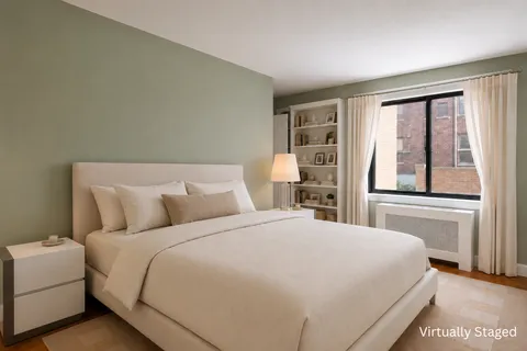 a bedroom with a large bed and a large window