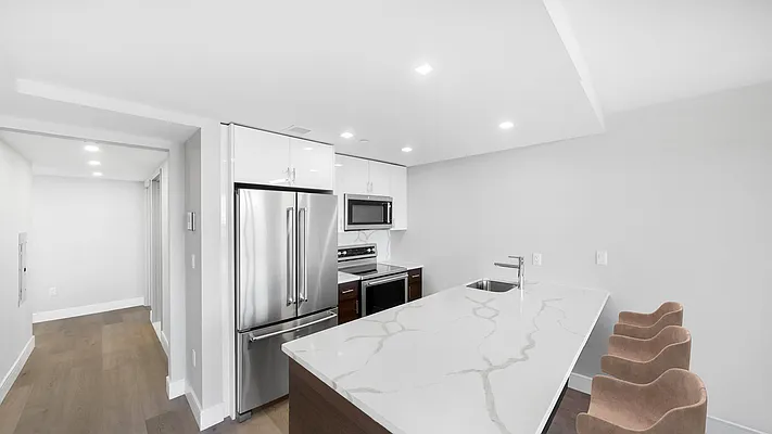 605 Hart Street, Unit 606 Brooklyn, NY 11221 - Photo 1 of 10 a kitchen with stainless steel appliances a refrigerator and microwave