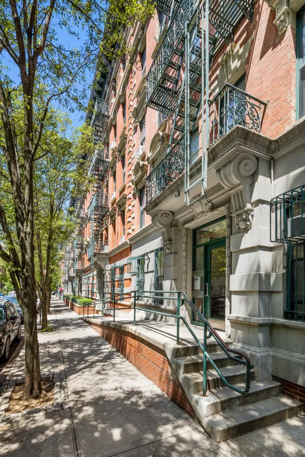 a view of a building with cars parked