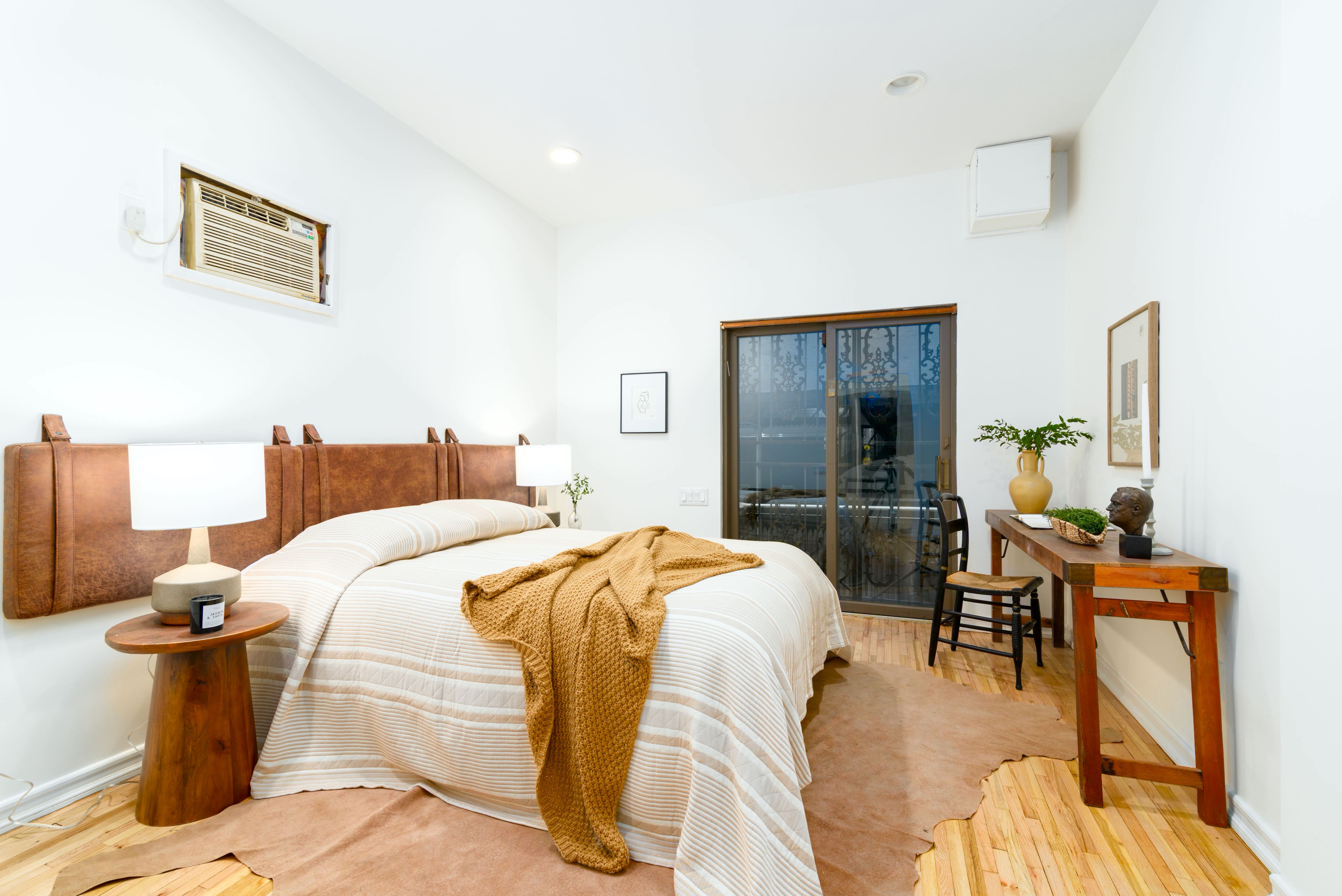 349 West 71st Street Manhattan, NY 10023 - Photo 15 of 21 a bedroom with a bed and wooden floor