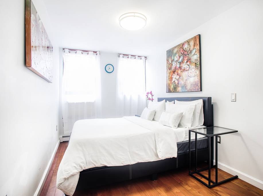 153 Stanton Street, Unit A1 Manhattan, NY 10002 - Photo 4 of 16 a bedroom with a bed and a window