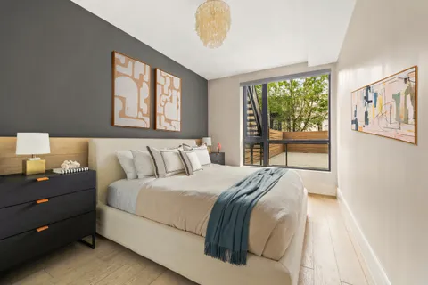 a bedroom with a large bed and a window