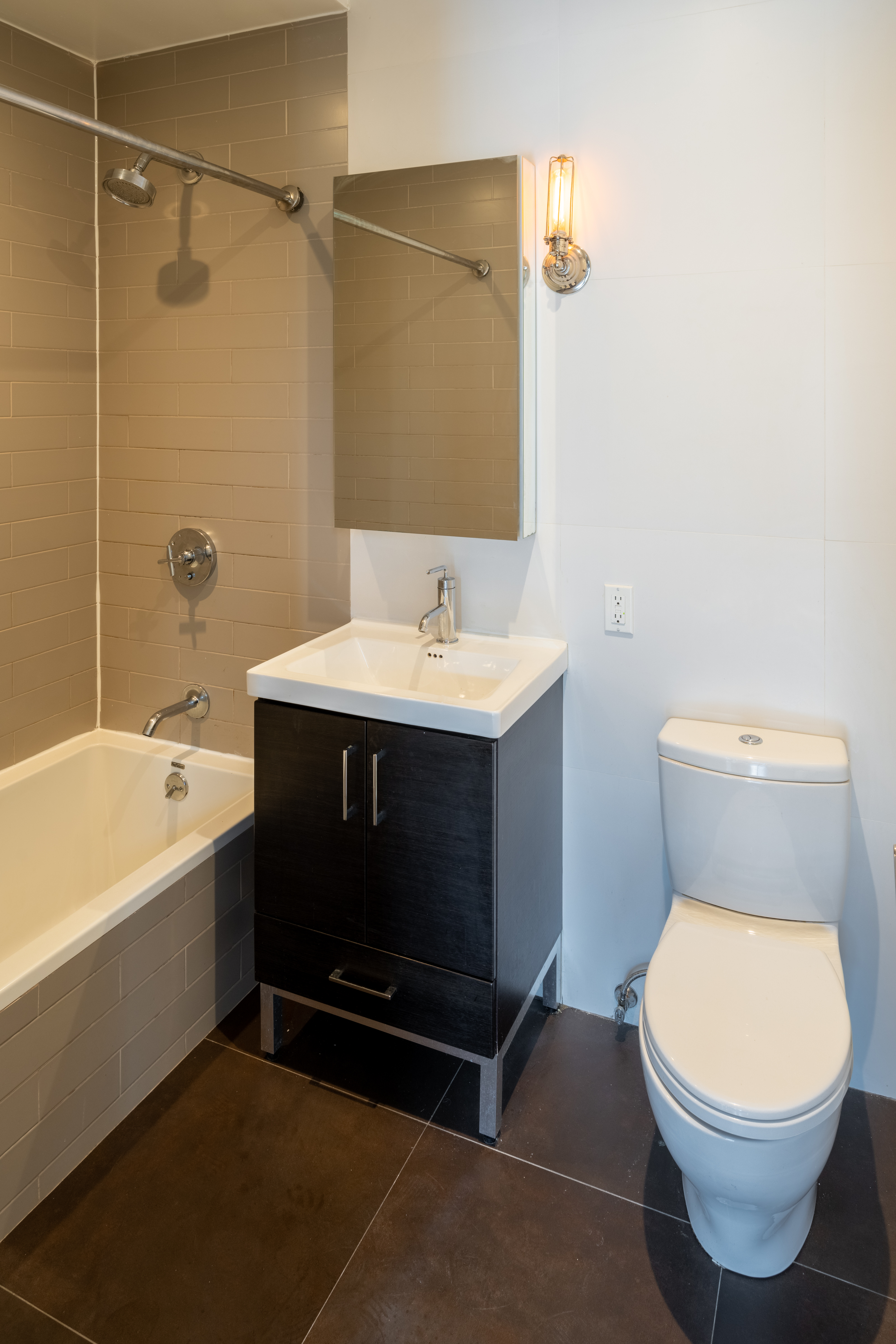 139 North 10th Street, Unit 4B Brooklyn, NY 11249 - Photo 5 of 10 a bathroom with a sink a toilet and shower