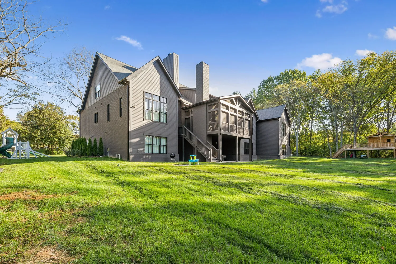 a big house with a big yard and large trees