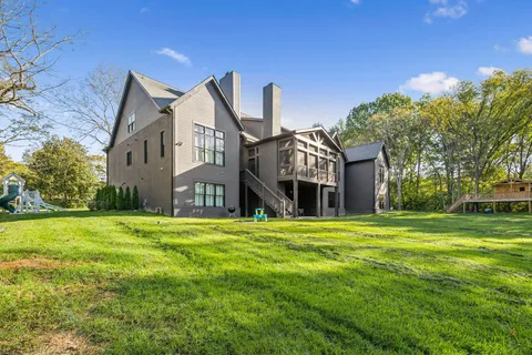 a big house with a big yard and large trees