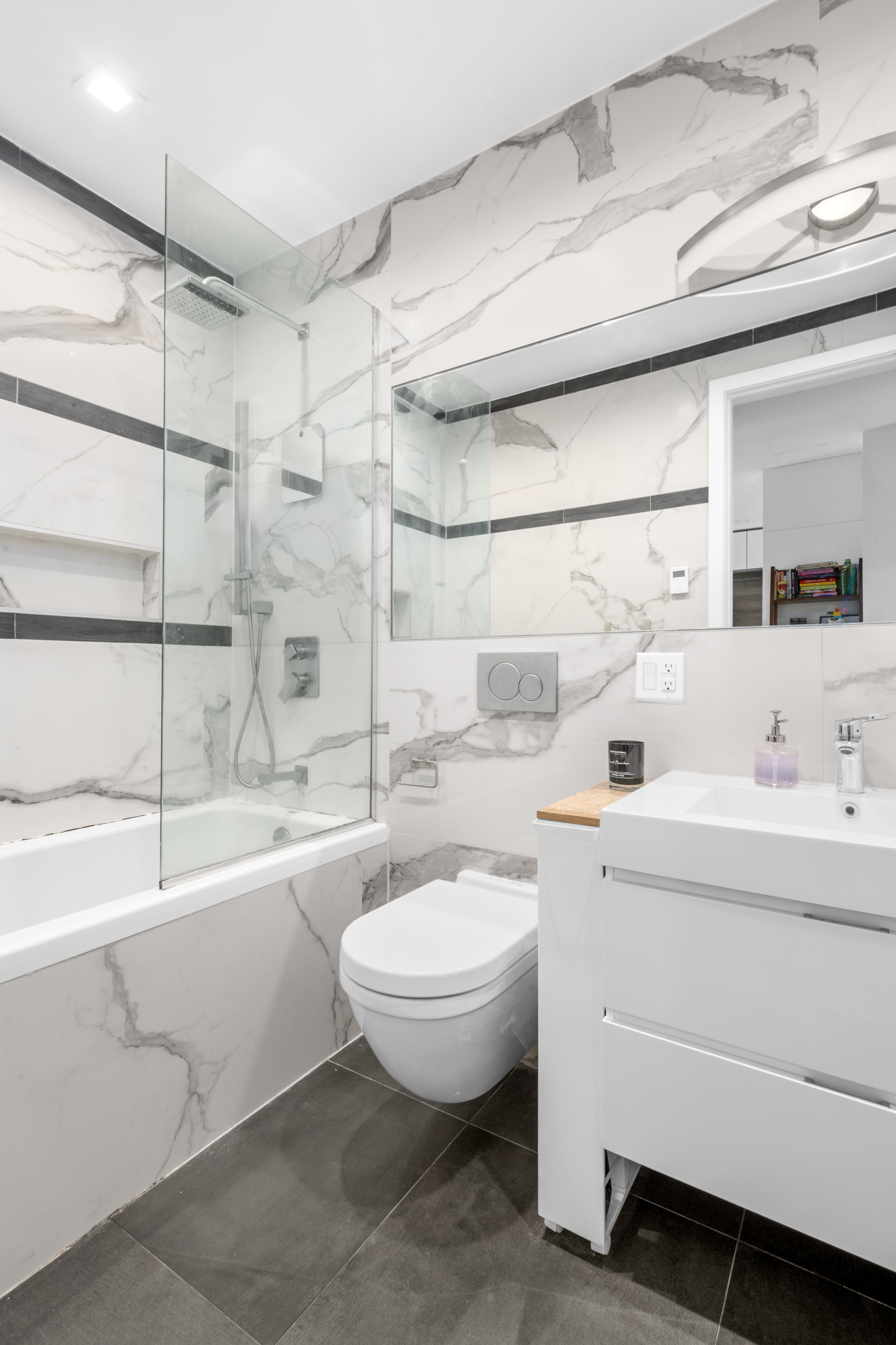 203 Quincy Street, Unit 4B Brooklyn, NY 11216 - Photo 8 of 11 a bathroom with a sink a toilet and shower