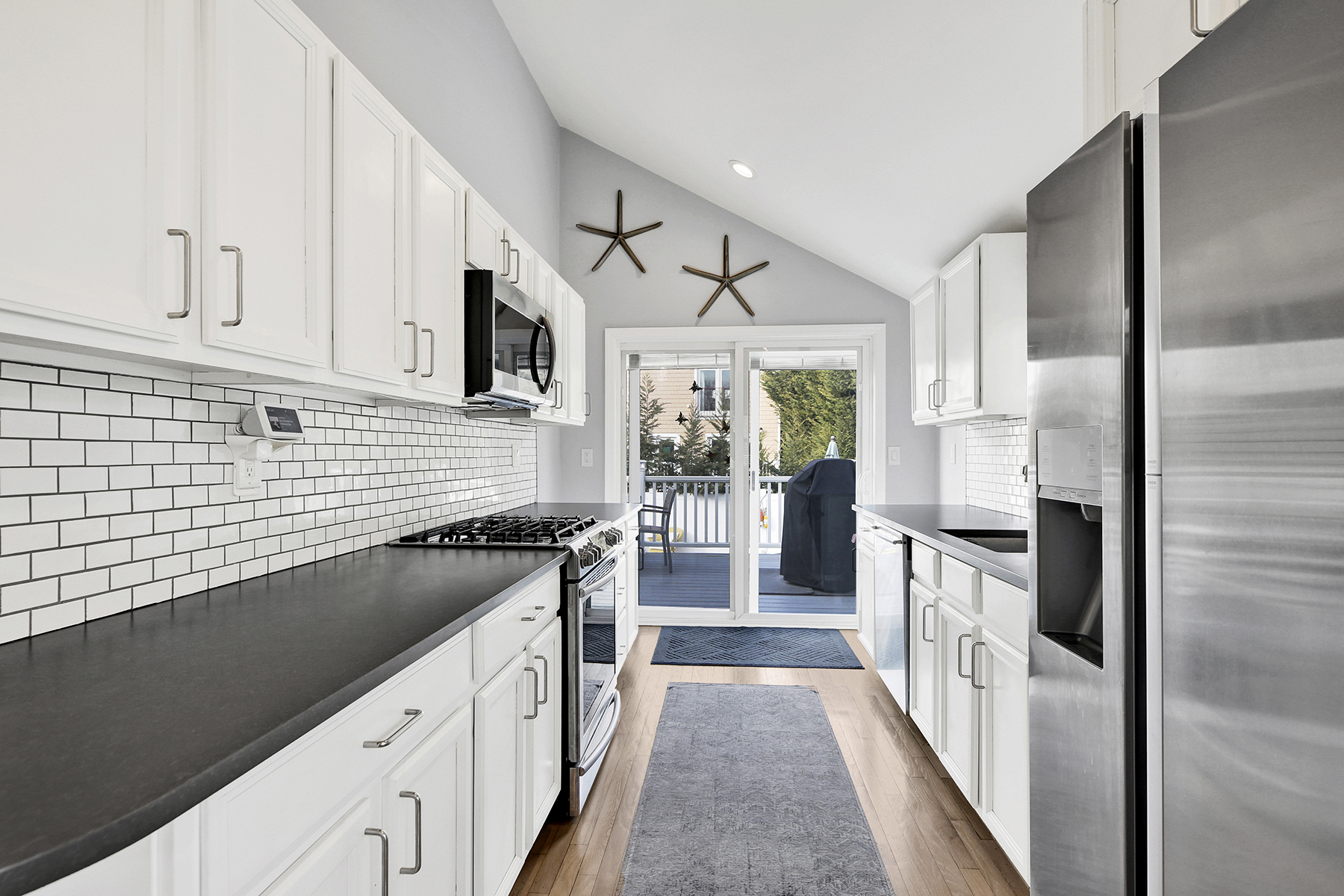 4-53 Beach 142nd Street Queens, NY 11694 - Photo 15 of 39 a kitchen with stainless steel appliances granite countertop a sink stove and refrigerator