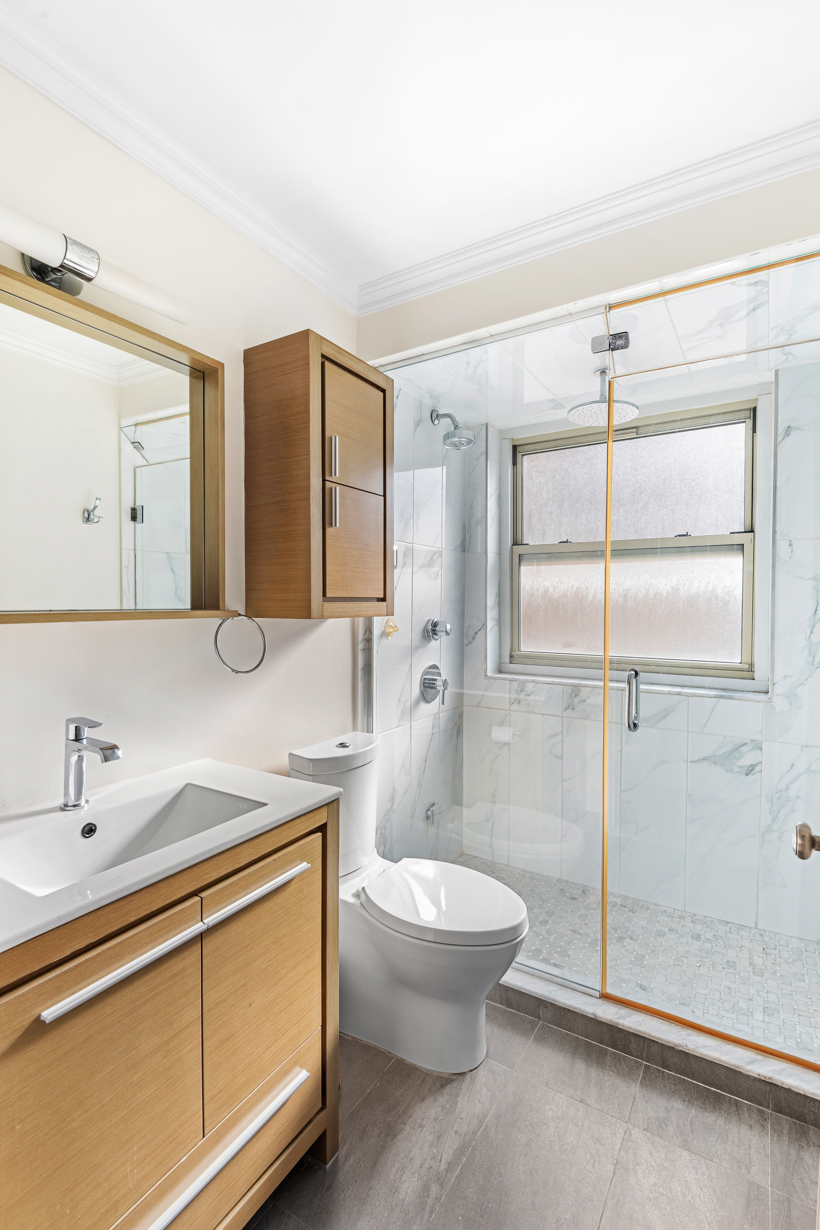 137 East 36th Street, Unit 21F Manhattan, NY 10016 - Photo 12 of 19 a bathroom with a sink a toilet and shower