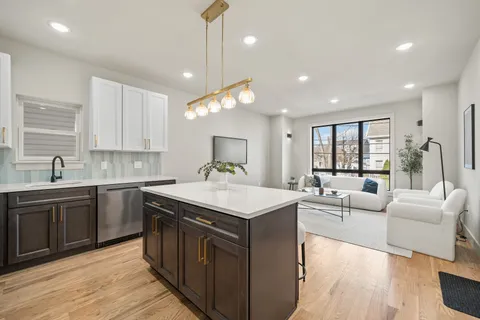a kitchen with a stove sink and cabinets