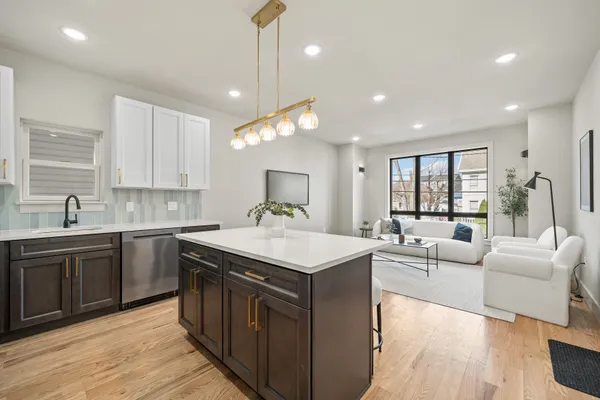a kitchen with a stove sink and cabinets