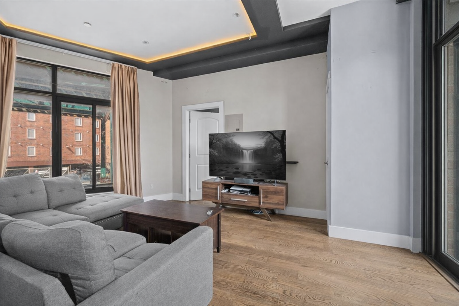 83 Suydam Street, Unit TWOFAMILY Brooklyn, NY 11221 - Photo 2 of 11 a living room with furniture and a flat screen tv