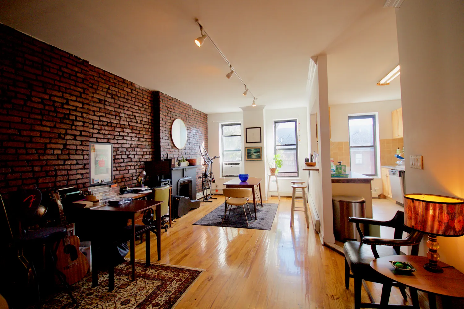 a living room with furniture and wooden floor