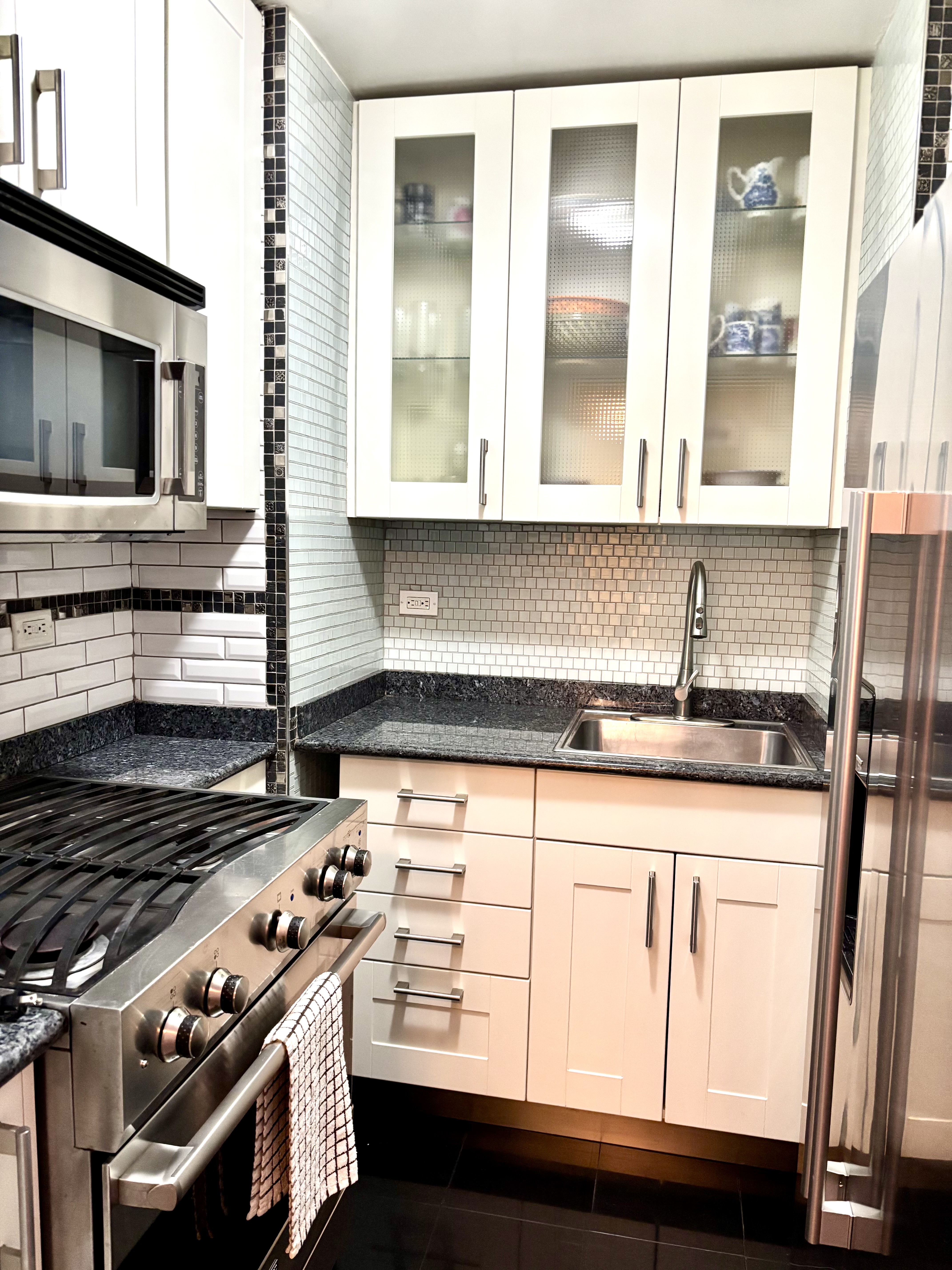 1270 5th Avenue, Unit 3B Manhattan, NY 10029 - Photo 2 of 7 a kitchen with granite countertop a stove and a sink