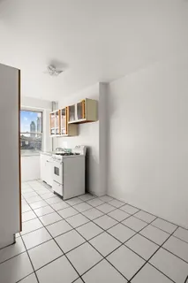a kitchen with a stove top oven and cabinets