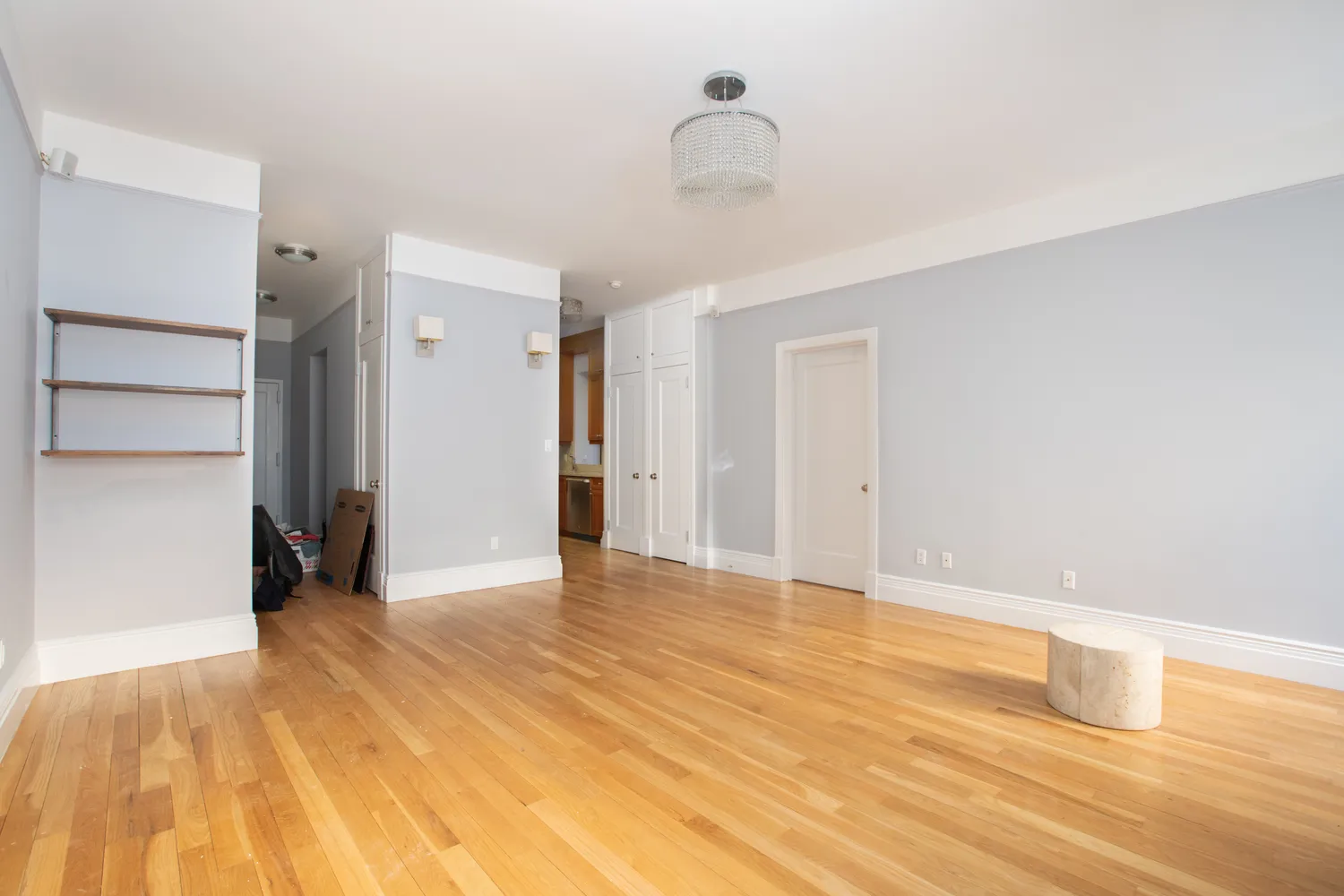 a view of an empty room with wooden floor