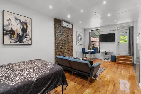 a bedroom with furniture and a flat screen tv