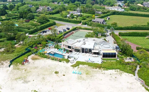 an aerial view of a house with a yard basket ball court and outdoor seating