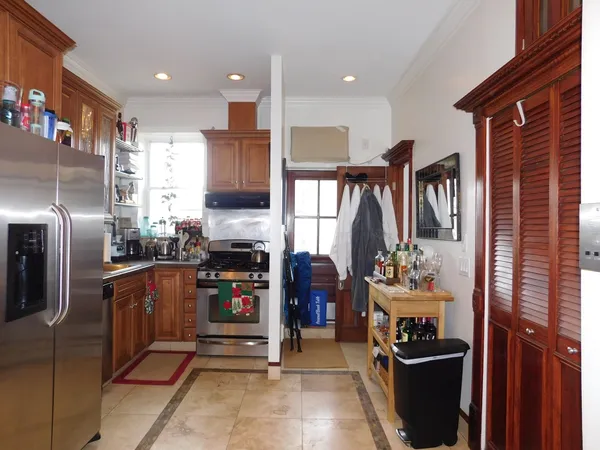 a kitchen with stainless steel appliances granite countertop a refrigerator and a stove top oven