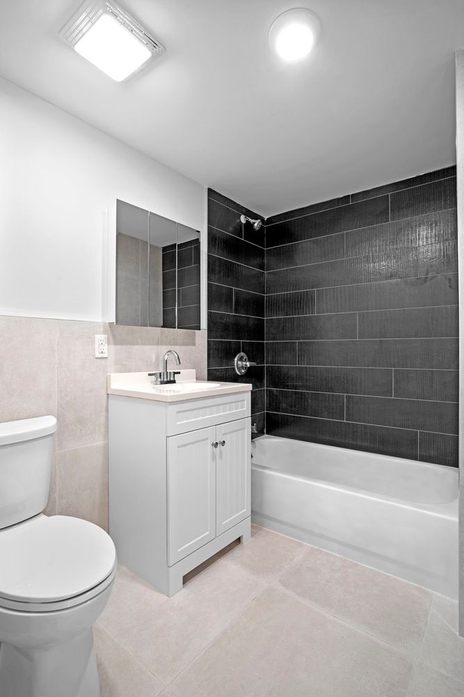 791 Lexington Avenue, Unit 2 Brooklyn, NY 11221 - Photo 15 of 19 a bathroom with a double vanity sink toilet and shower