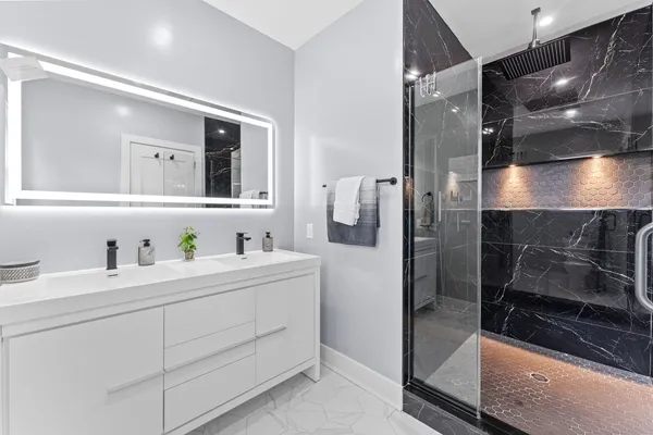 a bathroom with a shower sink and mirror