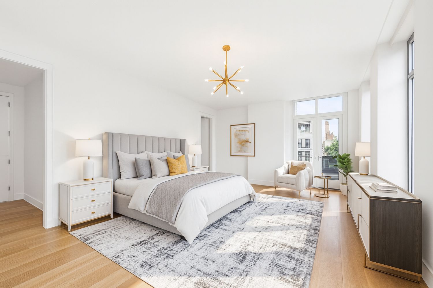 a bedroom with a large bed and a chandelier