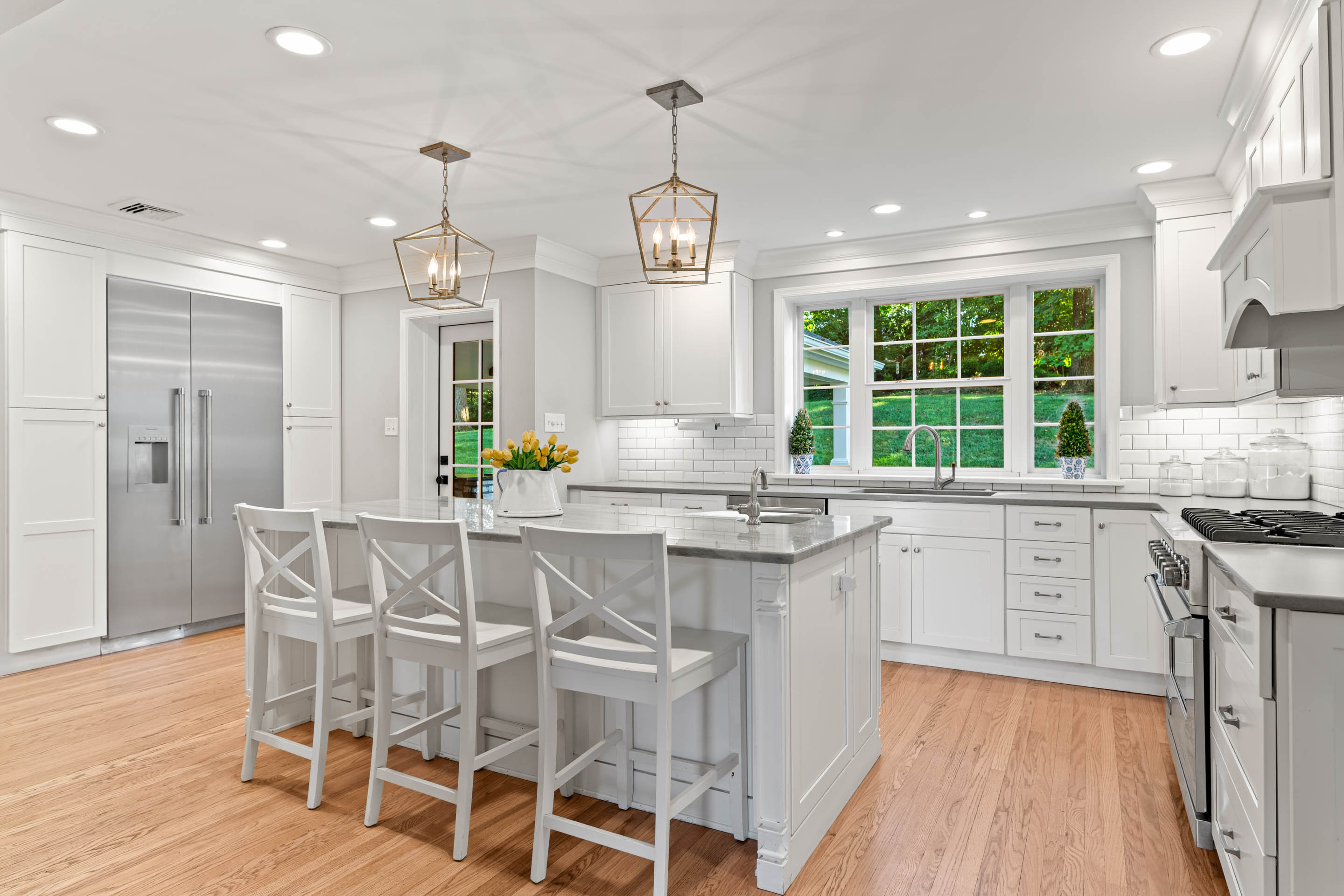 710 South Valley Forge Road Devon, PA 19333 - Photo 8 of 47 a kitchen with stainless steel appliances granite countertop a stove top oven a refrigerator a sink and white cabinets with wooden floor