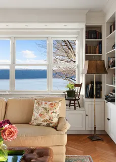 a living room with furniture and a book shelf