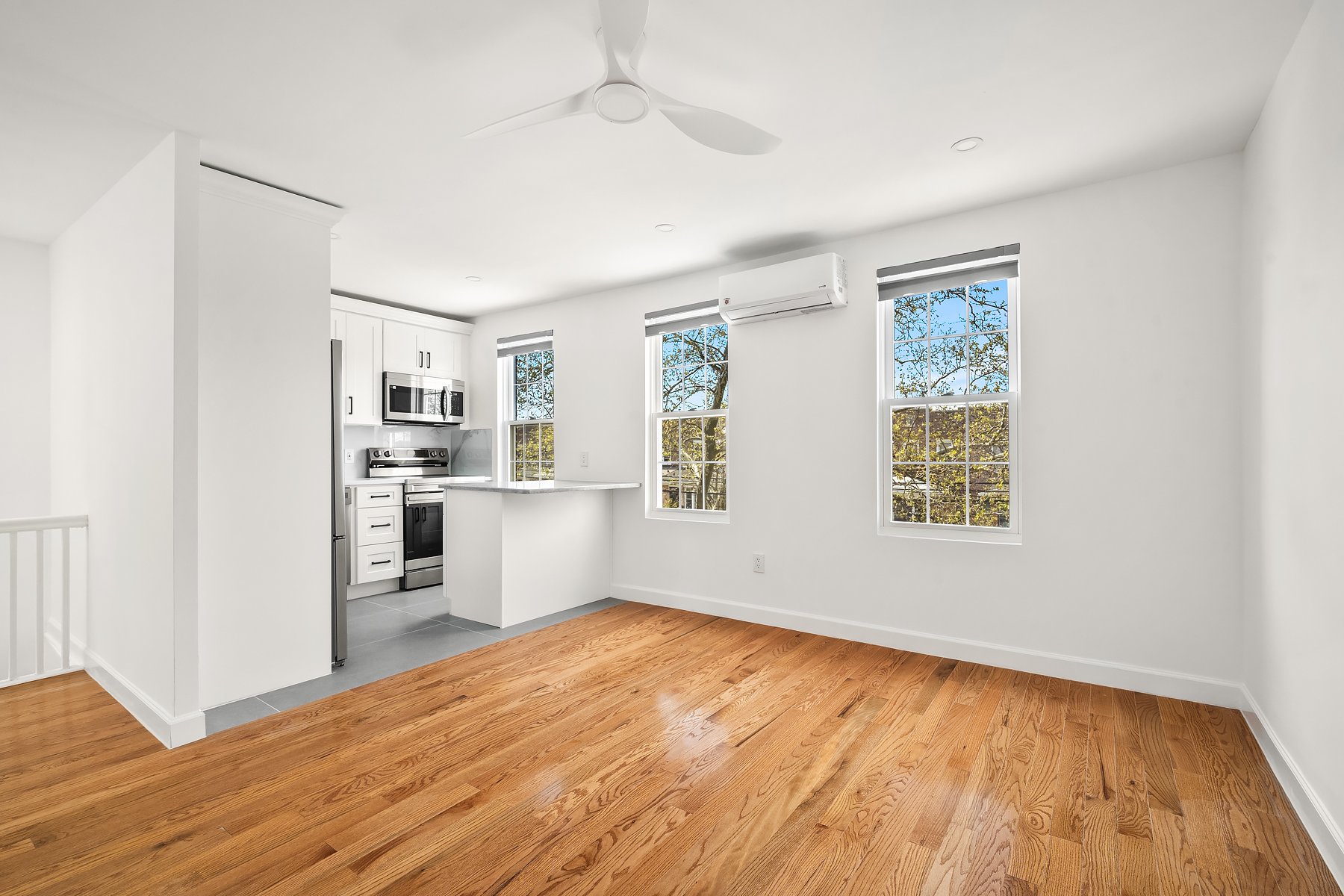 50-35 46th Street, Unit 2 Queens, NY 11377 - Photo 1 of 7 a view of a kitchen with wooden floor electronic appliances and windows
