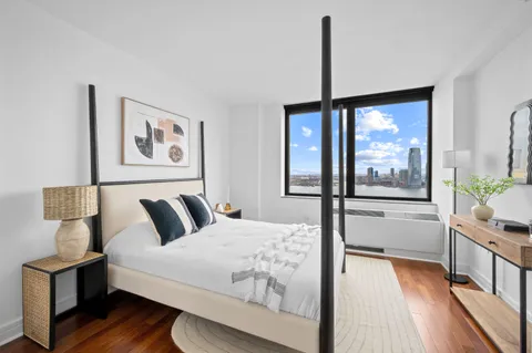 a bedroom with a large bed and a window