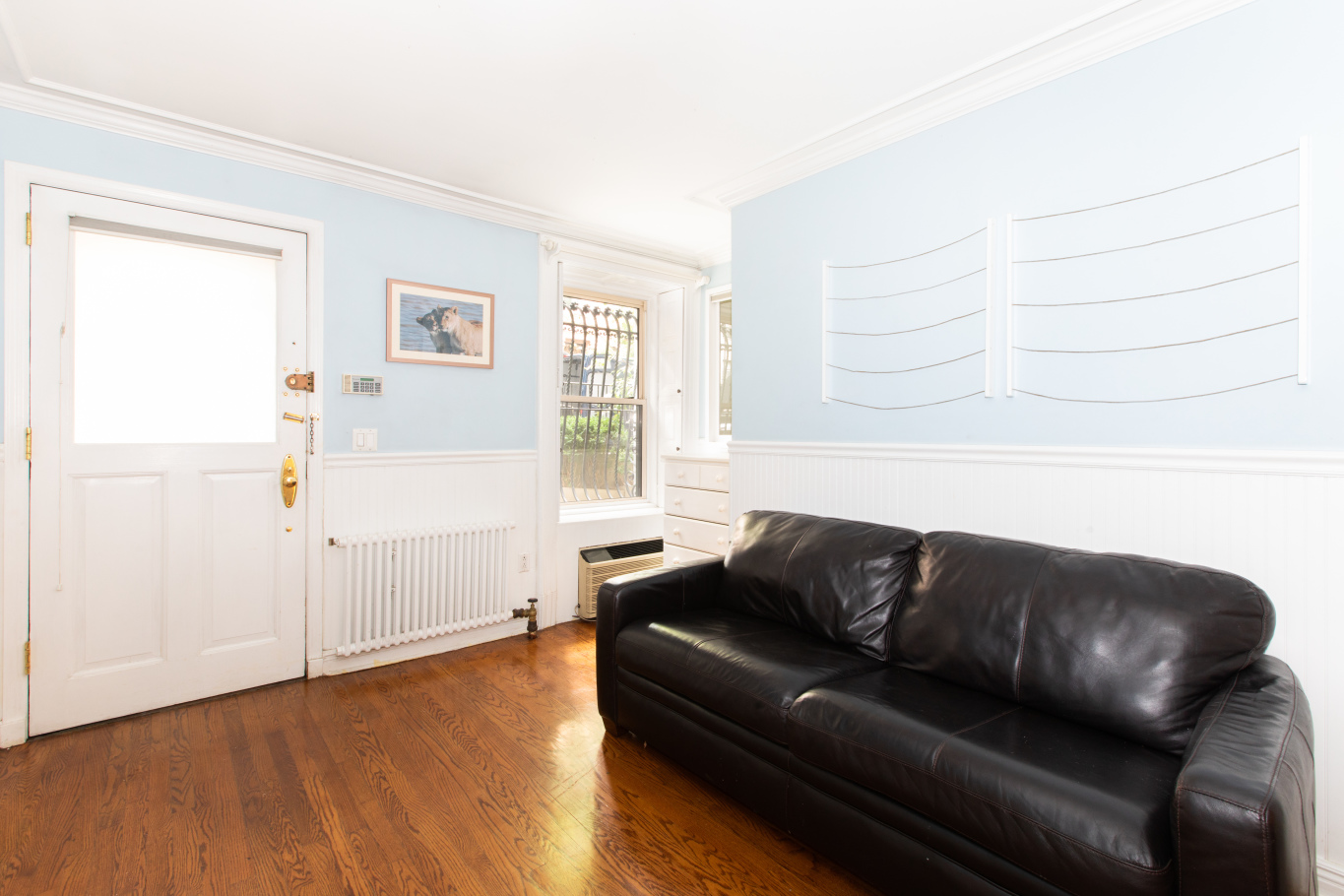 27 West 87th Street, Unit 1 Manhattan, NY 10024 - Photo 10 of 12 a living room with furniture and a wooden floor