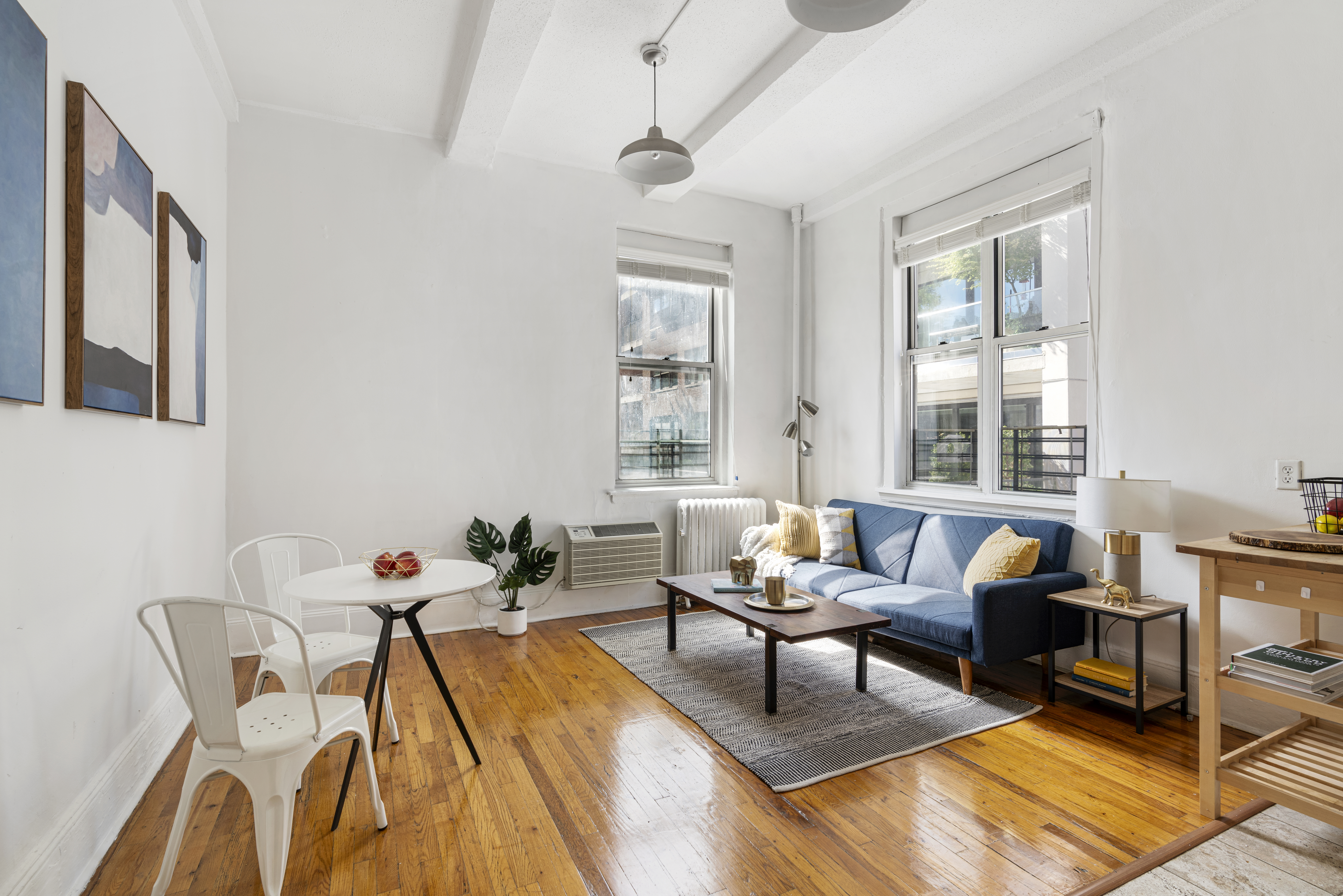 458 West 20th Street, Unit 3D Manhattan, NY 10011 - Photo 2 of 9 a living room with furniture and a window