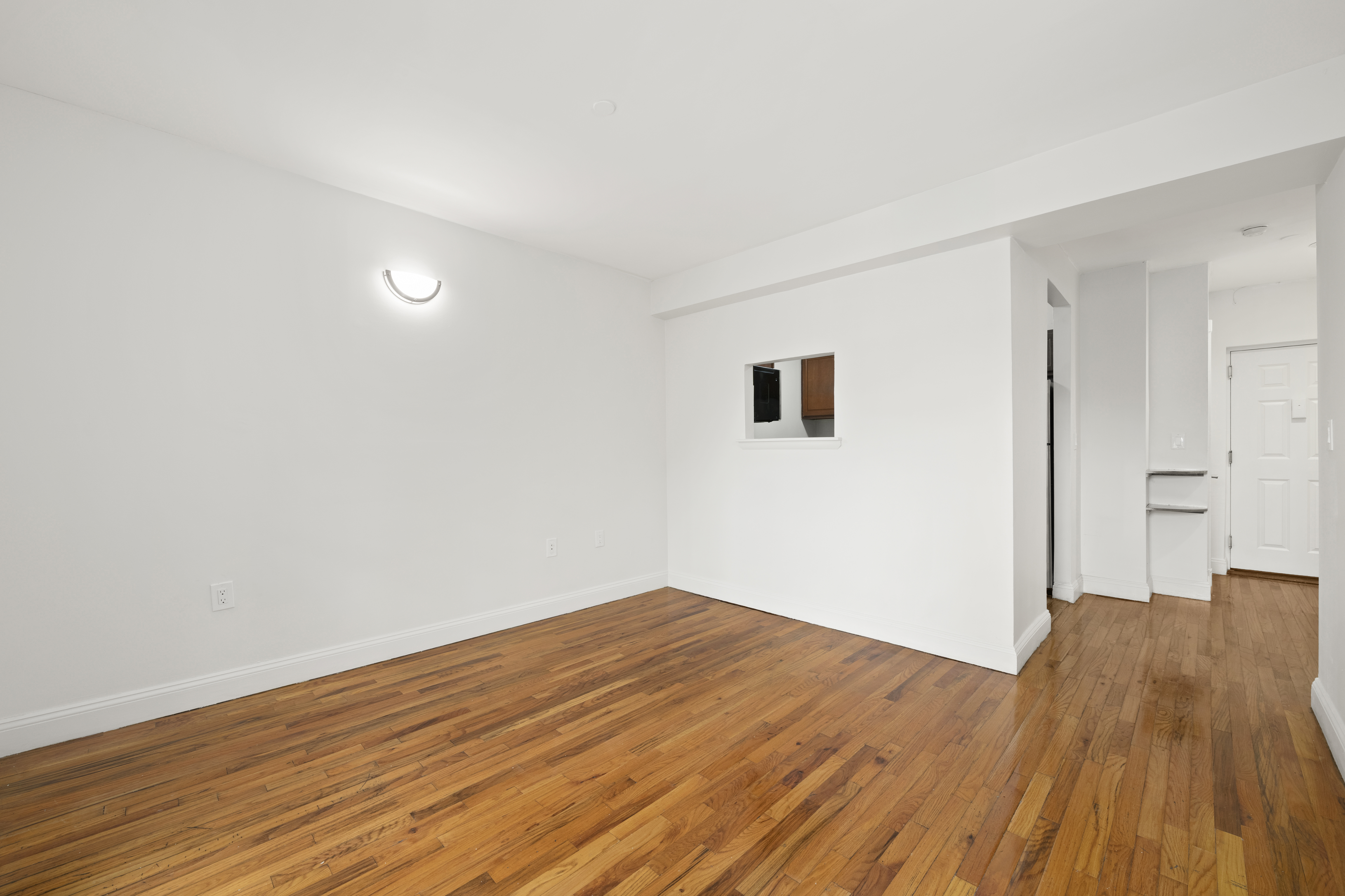 1240 Bedford Avenue, Unit 3H Brooklyn, NY 11216 - Photo 4 of 12 a view of a room with wooden floor and white walls