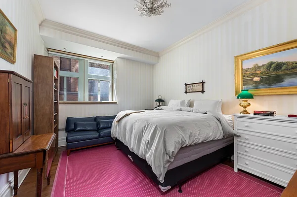 1 West 67th Street, Unit 2M Manhattan, NY 10023 - Photo 6 of 16 a bedroom with a bed and a window