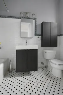 a bathroom with a sink toilet and mirror