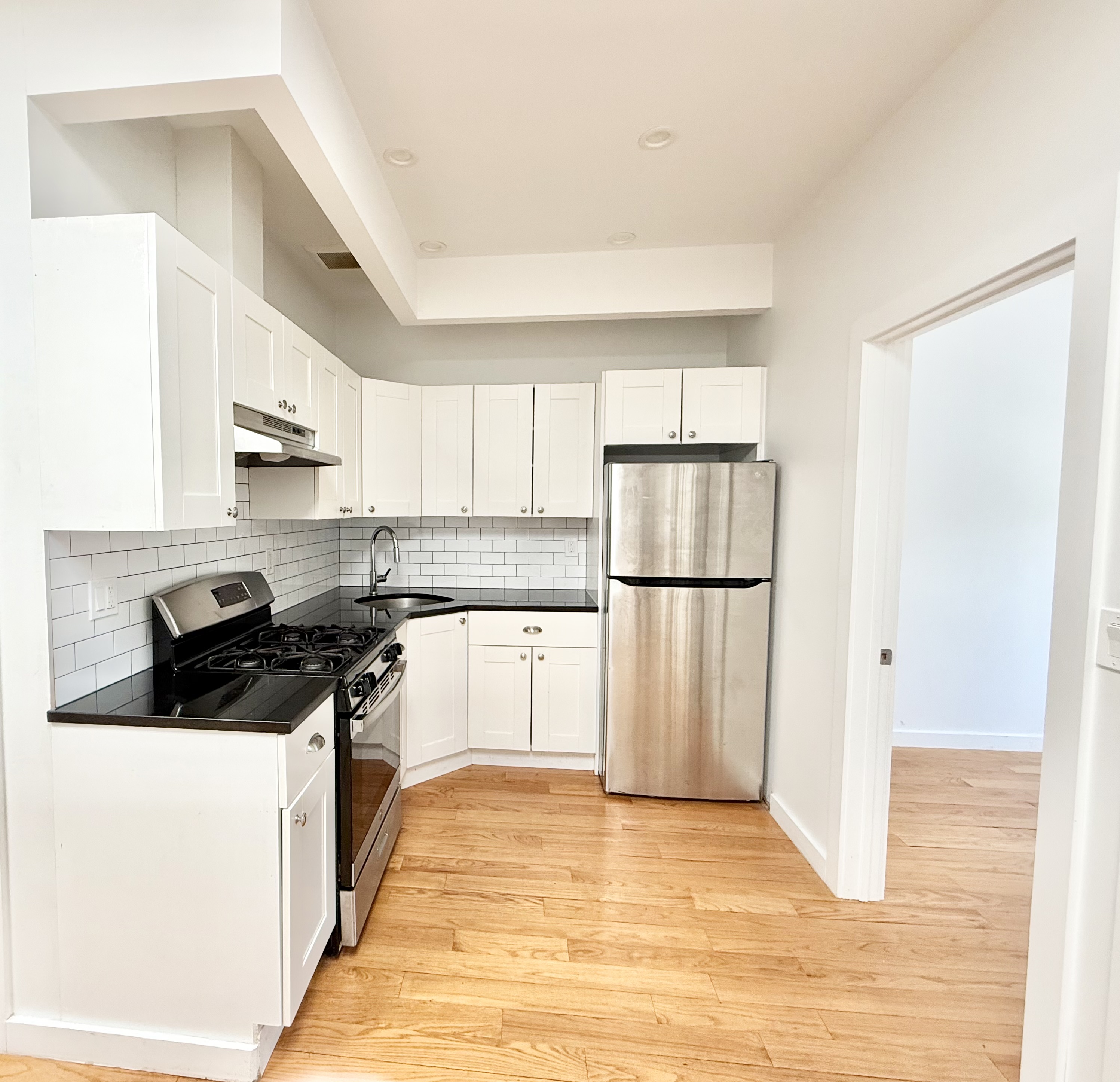2013 Flatbush Avenue, Unit 2R Brooklyn, NY 11234 - Photo 4 of 11 a kitchen with stainless steel appliances granite countertop a stove a refrigerator and a refrigerator