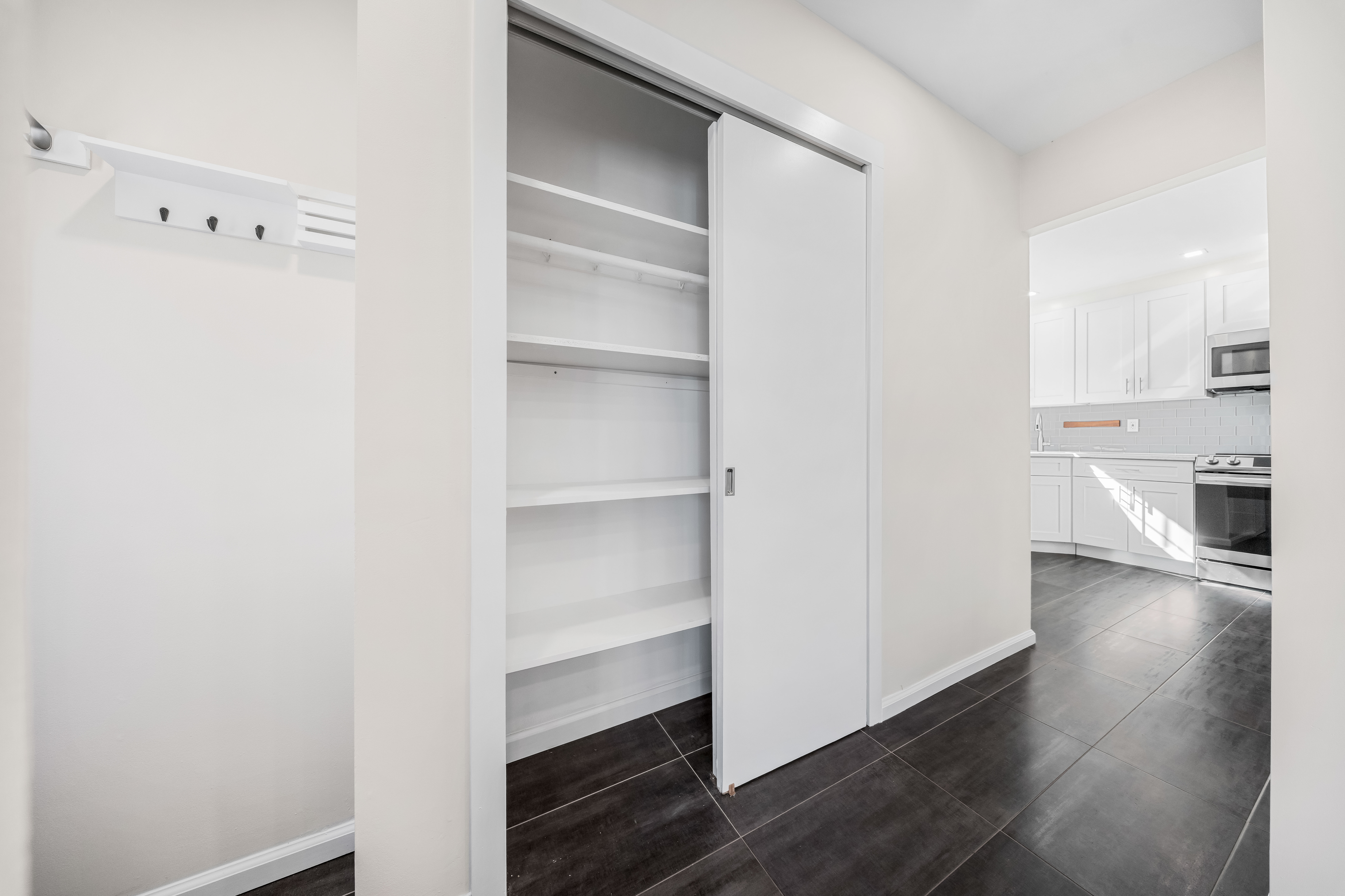 15-80 209th Street, Unit 2 Queens, NY 11360 - Photo 5 of 21 a view of cabinets and wooden floor