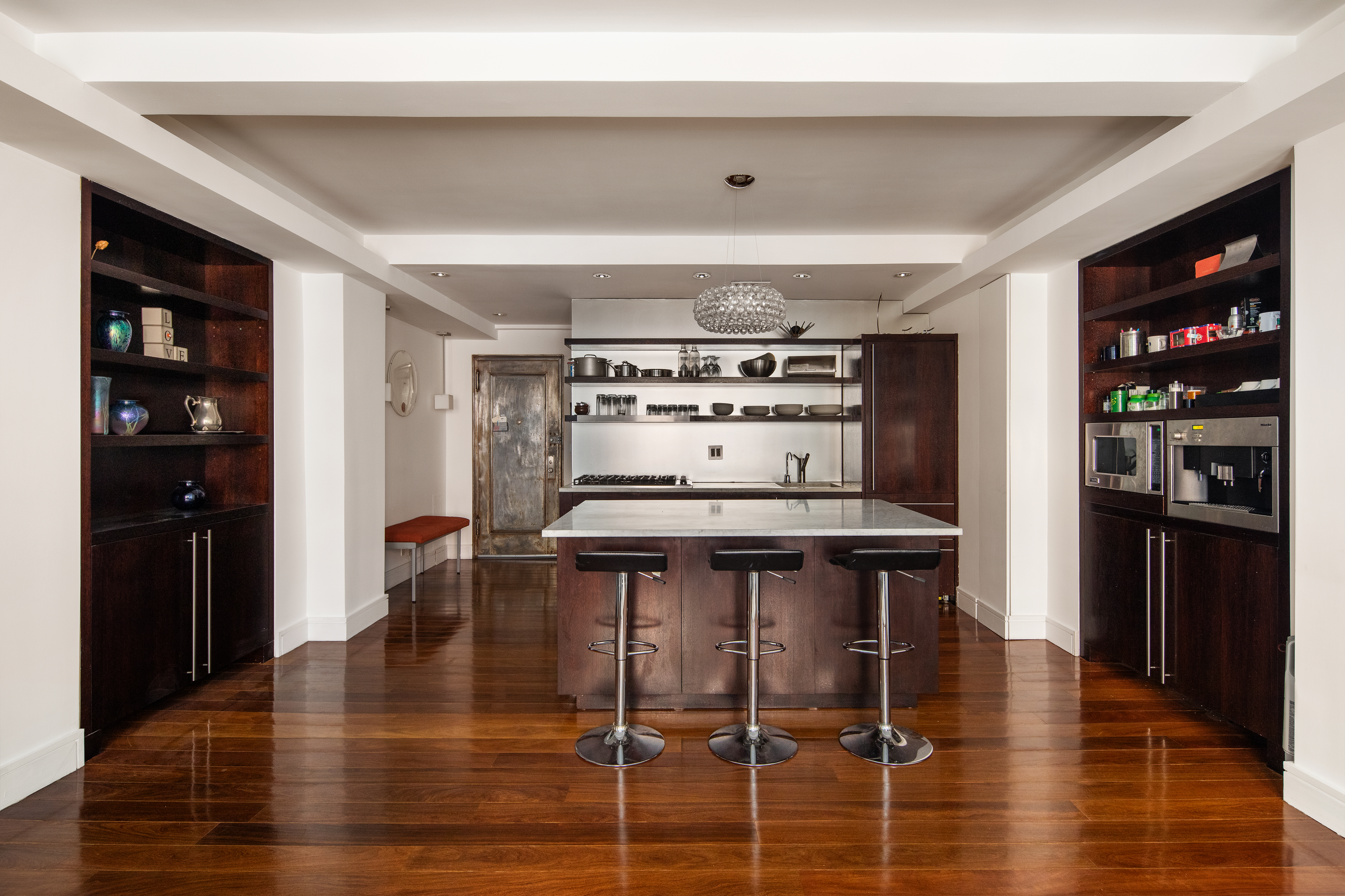 410 West 24th Street, Unit 4J Manhattan, NY 10011 - Photo 2 of 11 a kitchen with granite countertop a stove and cabinets