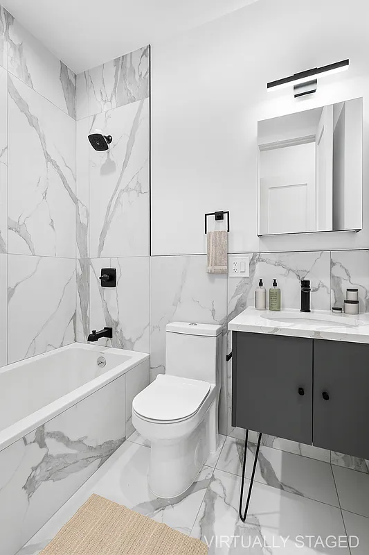 162 Cornelia Street, Unit 3 Brooklyn, NY 11221 - Photo 5 of 9 a bathroom with a sink toilet a mirror and bathtub
