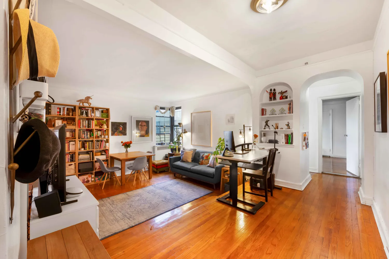 a living room with furniture and a wooden floor