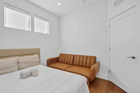 a bedroom with a bed and a window