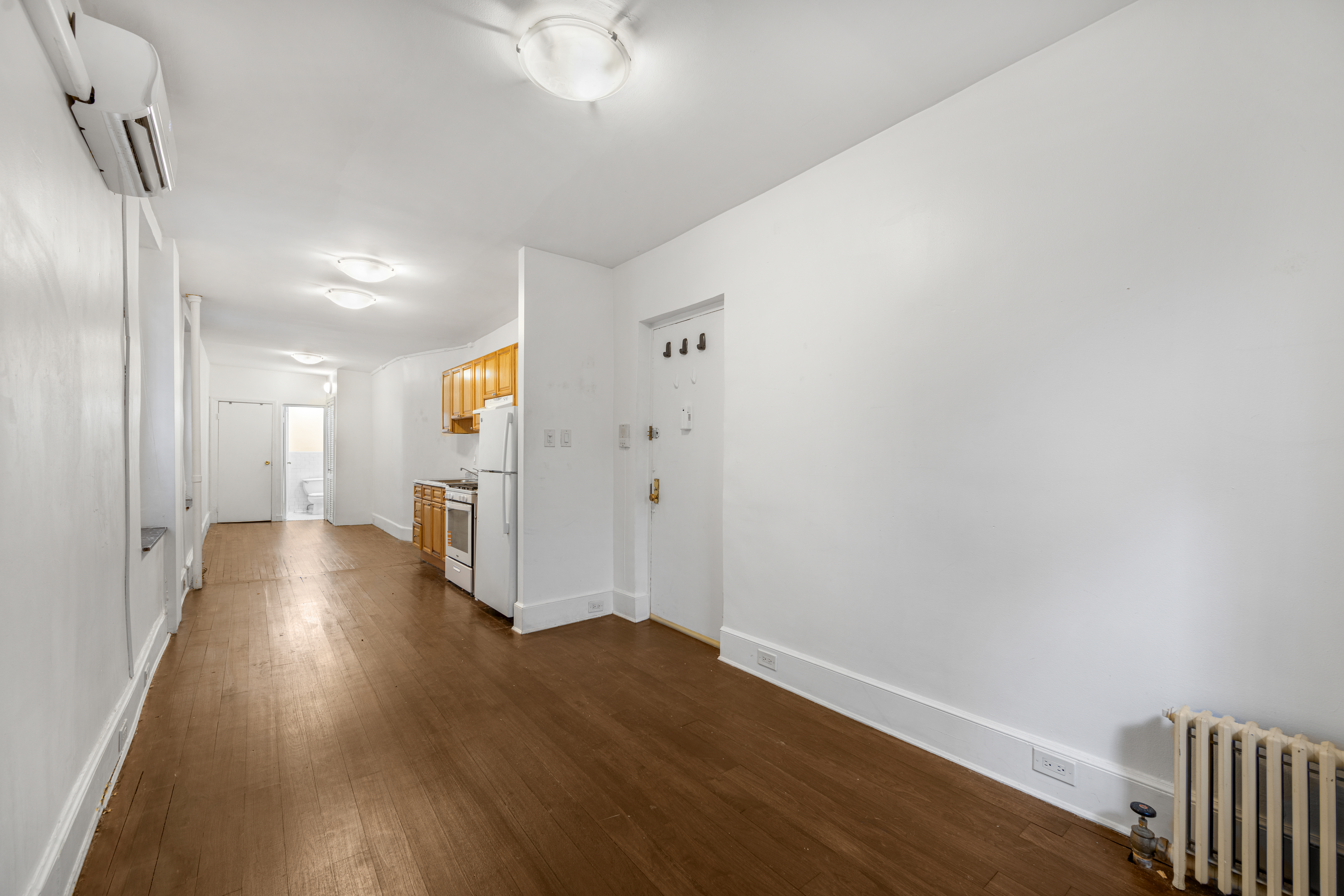241 Mulberry Street, Unit 3 Manhattan, NY 10012 - Photo 1 of 8 a view of a hallway with wooden floor