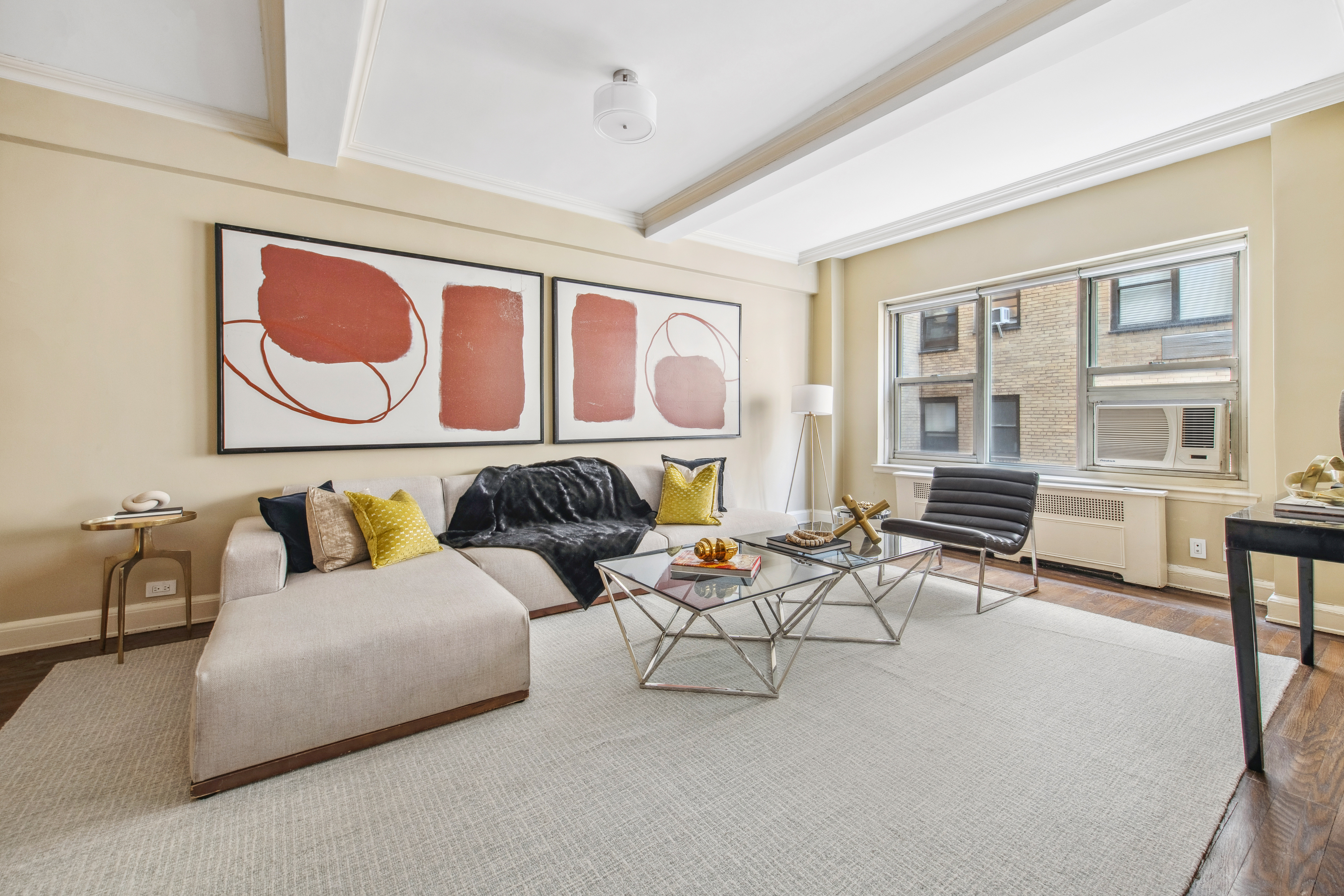 400 East 52nd Street, Unit 6K Manhattan, NY 10022 - Photo 2 of 8 a living room with furniture and a window