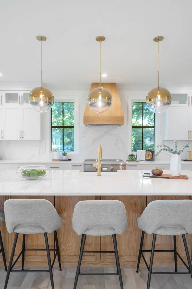 a kitchen with a dining table chairs and a chandelier