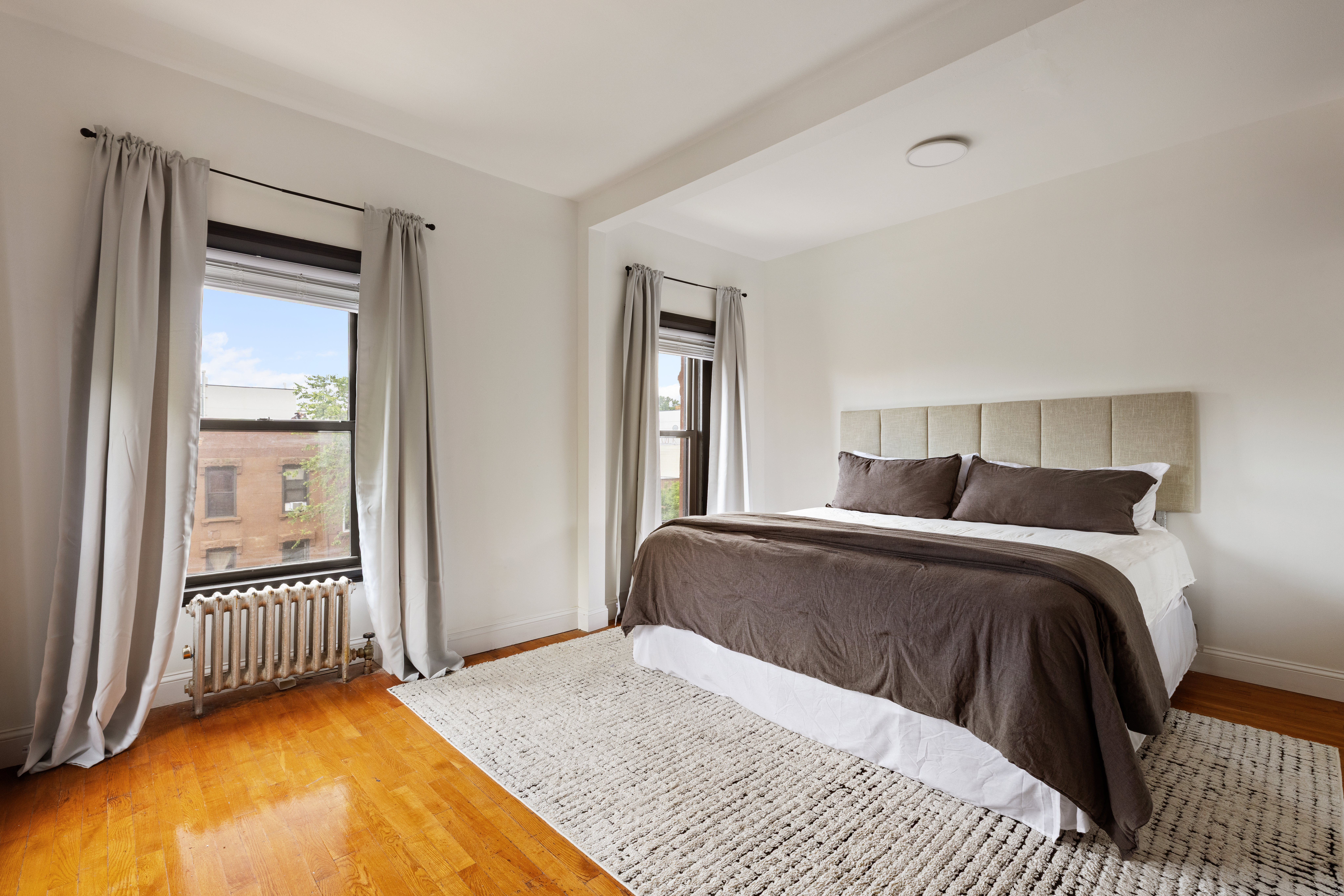 663 Greene Avenue Brooklyn, NY 11221 - Photo 10 of 14 a bedroom with a bed and a window