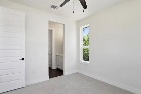 an empty room with windows and closet